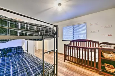 a bedroom with two bunk beds and a crib at North Fork Vacation Rental 28 Mi to Yosemite in North Fork