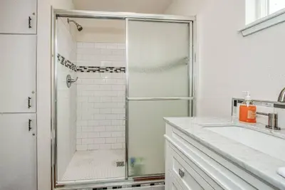 a white bathroom with a shower and a sink at Totally New Awesome North Fresno Back Studio in Fresno