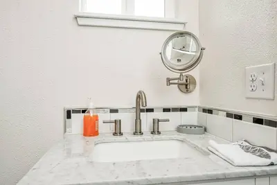 a white bathroom with a sink and a mirror at Totally New Awesome North Fresno Back Studio in Fresno