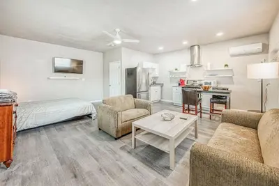a living room with a bed a couch and a table at Stylish Studio 89 Brand New from the floor up in Fresno