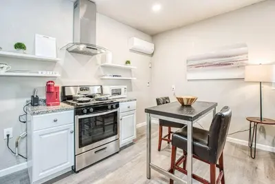 a kitchen with a table and a stove at Stylish Studio 89 Brand New from the floor up in Fresno