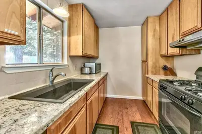 a kitchen with a sink and a stove at Lake Views in 3bdr Family Home w/ Hottub in South Lake Tahoe