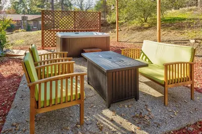 a group of chairs and a table and a grill at Yosemite Corner w NEW game room/Hot Tub/EV more in Oakhurst
