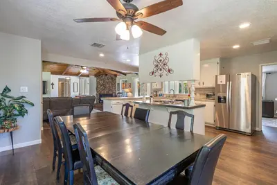 a dining room and kitchen with a table and chairs at Starry Pines- Pet friendly/spa/affordable in Oakhurst