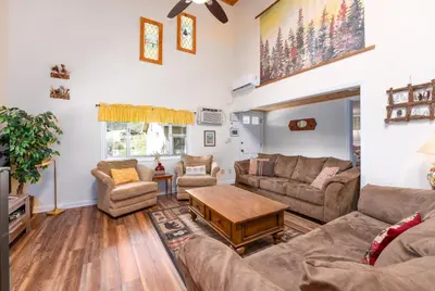 a living room with a couch and a table at Selah Cabin- Dog Friendly/BBQ/Level 2 EV Charger in Oakhurst