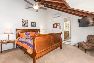 a bedroom with a bed and a flat screen tv at Selah Cabin- Dog Friendly/BBQ/Level 2 EV Charger in Oakhurst