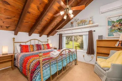 a bedroom with a bed and a window at Selah Cabin- Dog Friendly/BBQ/Level 2 EV Charger in Oakhurst