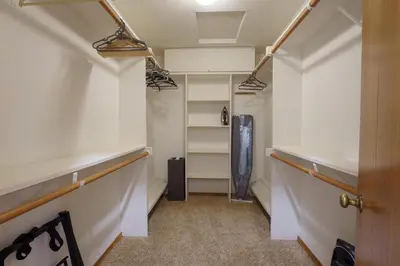a walk in closet with white walls and shelves at Summit Cabin Stunning home Loaded with amenities in Oakhurst