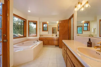 a large bathroom with a tub and a sink at Summit Cabin Stunning home Loaded with amenities in Oakhurst
