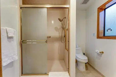 a bathroom with a shower and a toilet at Summit Cabin Stunning home Loaded with amenities in Oakhurst