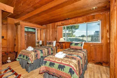 a bedroom with three beds in a wooden room at Eagles Nest at Bass Lake near Yosemite with Boat Dock in Bass Lake