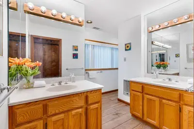 a bathroom with two sinks and a large mirror at Eagles Nest at Bass Lake near Yosemite with Boat Dock in Bass Lake