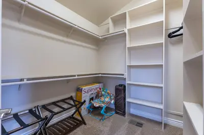 a walk in closet with white shelves and a table at Yosemite Adventure House with Pool-hot tub-game room in Oakhurst