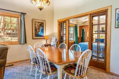 a dining room with a wooden table and chairs at Place to Call Home - Cabin INSIDE Yosemite - Dog Friendly in South Wawona