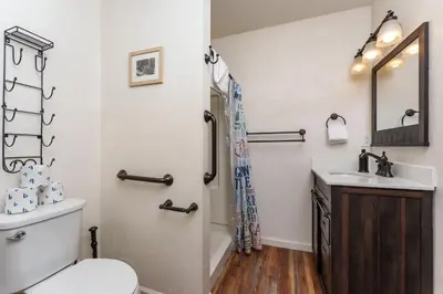 a bathroom with a toilet and a sink at Stimboli Lodge- Sleeps 16 with tons of games and fun in Oakhurst