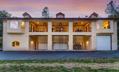 a large white house with a garage at Big Oak Manor w/theater/hot tub/sauna/more in Oakhurst