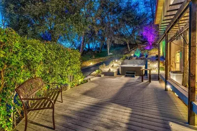 a porch with two benches and a couch on a house at Big Oak Manor w/theater/hot tub/sauna/more in Oakhurst