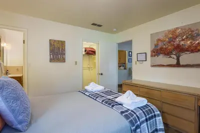 a bedroom with a bed with two towels on it at Peace of Mine - Cabin inside Yosemite - Dog Friendly in South Wawona