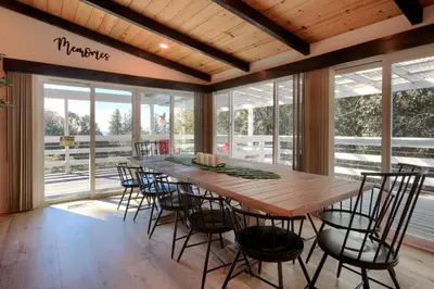 a large dining room with a wooden table and chairs at Doe Cabin Hot Tub/Playground/Game Room and more in Oakhurst