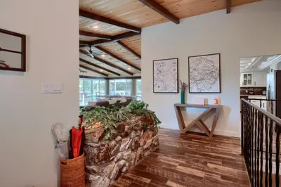 a living room with a couch and a table at Doe Cabin Hot Tub/Playground/Game Room and more in Oakhurst