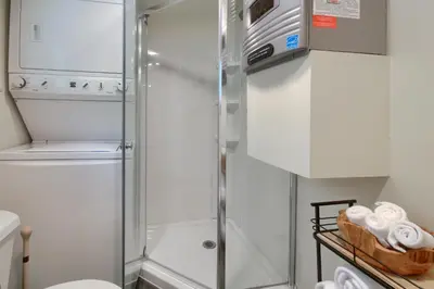 a shower with a glass door in a bathroom at Beetlebark Bungalow- Inside Yosemite w/ hot tub EV charging cable in North Wawona