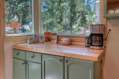 a kitchen with a counter with a coffee maker and a window at Beetlebark Bungalow- Inside Yosemite w/ hot tub EV charging cable in North Wawona