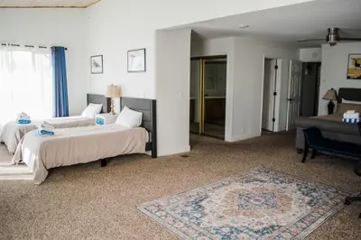 a bedroom with two beds and a living room at Canyon View House w/ hot tub, game room, views, and more in Oakhurst