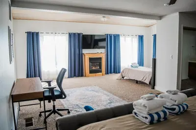 a living room with a couch and a fireplace at Canyon View House w/ hot tub, game room, views, and more in Oakhurst