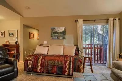 a bedroom with a bed and a sliding glass door at Hibernation Hideaway- Inside Yosemite- Dog Friendly in South Wawona