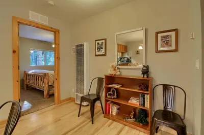 a living room with a table and chairs and a mirror at Hibernation Hideaway- Inside Yosemite- Dog Friendly in South Wawona