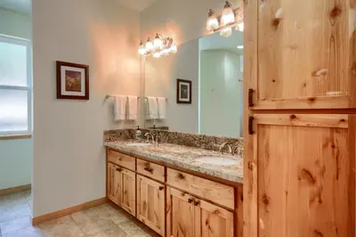 a bathroom with a double sink and a mirror at Rivercrest Lodge with Hot Tub-Pool Table-Firepit in North Wawona