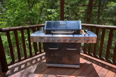 a grill sitting on a deck on a porch at Rivercrest Lodge with Hot Tub-Pool Table-Firepit in North Wawona