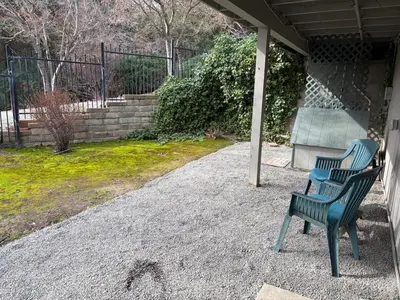 two blue chairs sitting on the porch of a house at Hodges Hill Hideout w/ pool, spa, BBQ - Dog Friendly in Oakhurst