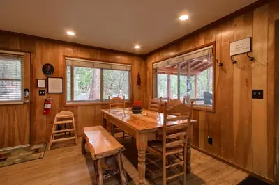 a dining room with a wooden table and chairs at Acorn Alley- inside Yosemite w/spa/firepit/sauna/EV in North Wawona