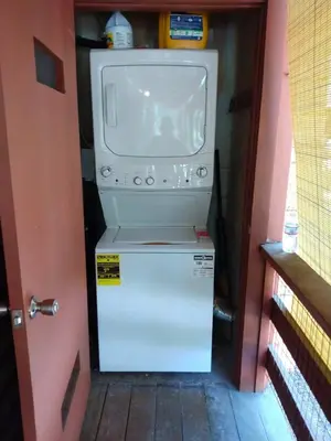 a washing machine sitting on top of a refrigerator at Acorn Alley- inside Yosemite w/spa/firepit/sauna/EV in North Wawona