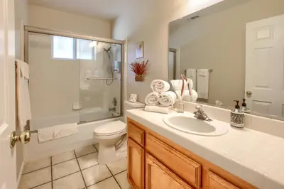 a bathroom with a sink and a toilet and a shower at Scenic Serenity 50 acres/hot tub/game room in Oakhurst