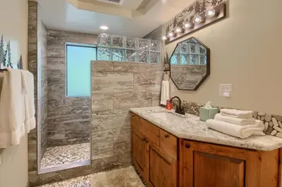 a bathroom with a shower and a sink at 3 Springs Hideout - Family cabin with hot tub in Yosemite in South Wawona