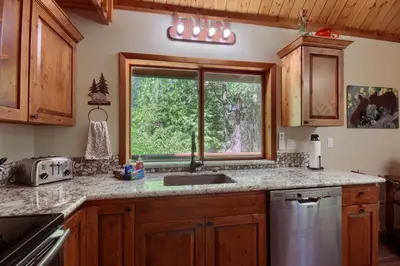 a kitchen with a sink and a window at 3 Springs Hideout - Family cabin with hot tub in Yosemite in South Wawona
