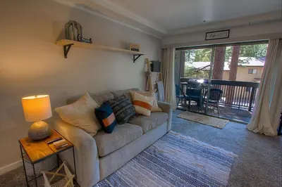 a living room with a couch and a table at Taste of Burgundy condo in Incline Village
