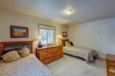 a bedroom with two beds and a dresser and a window at Tahoe Donner Greenbelt Retreat in Truckee