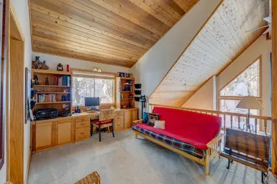 a red couch in a room with a desk at Tahoe Donner Greenbelt Retreat in Truckee