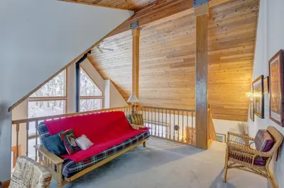 a living room with a red couch in a house at Tahoe Donner Greenbelt Retreat in Truckee