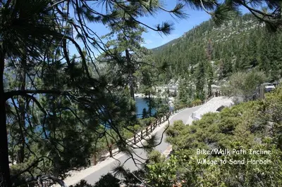 a view of a mountain road with a river and trees at Sugar PIne home in Incline Village