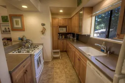 a kitchen with a sink and a stove top oven at Sugar PIne home in Incline Village