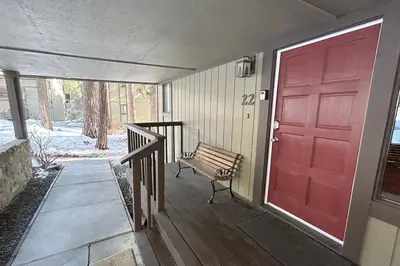 a porch with a red door and a bench at Brookstone Pines home in Incline Village