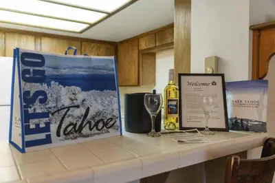 a counter with a bottle of wine and a wine glass at Heavenly Chairview Condo home in Stateline