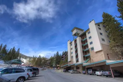 a large building with cars parked in a parking lot at Heavenly Chairview Condo home in Stateline