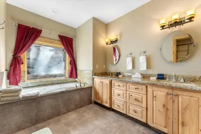 a bathroom with two sinks and a tub at Stage Coach Run home in Stateline