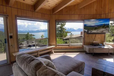 a living room with a couch and large windows at The Heights home in Zephyr Cove