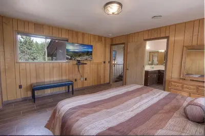 a bedroom with a large bed and a sink at The Heights home in Zephyr Cove